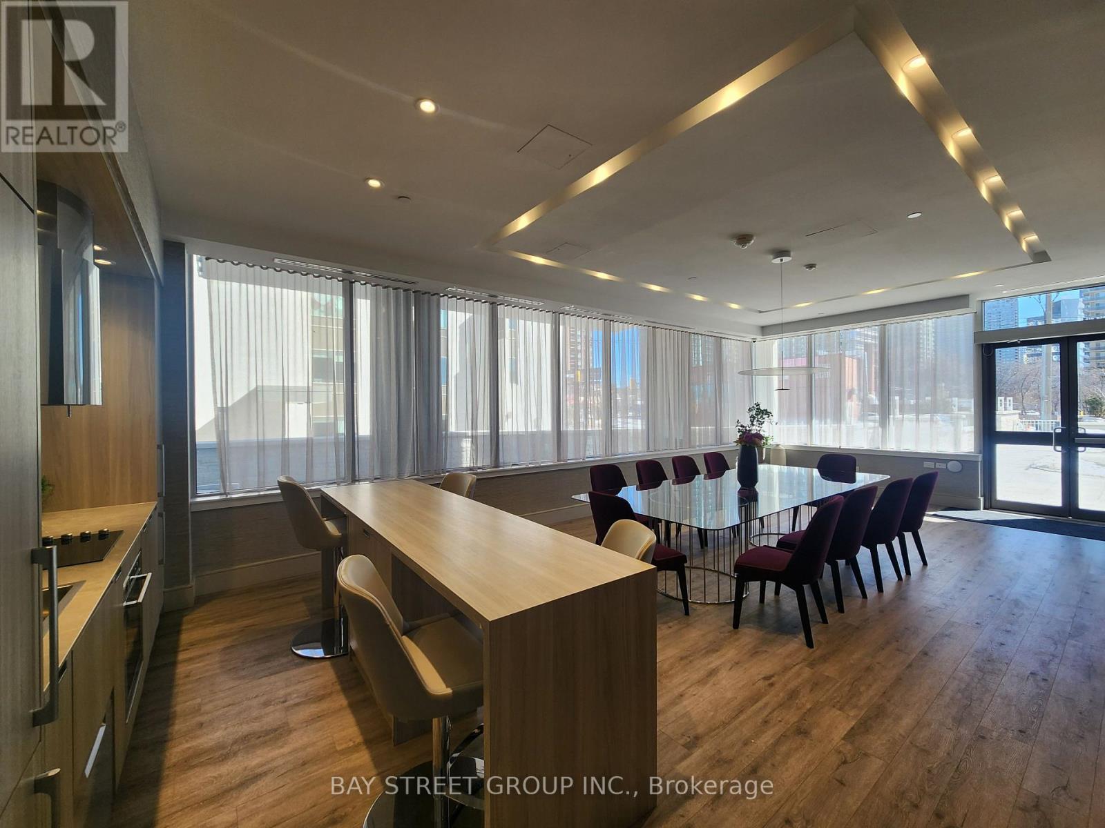 A conference room with a long table and chairs is shown.