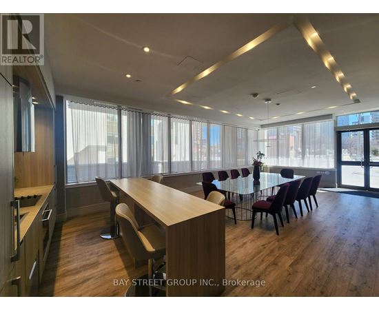 A conference room with a long table and chairs is shown.