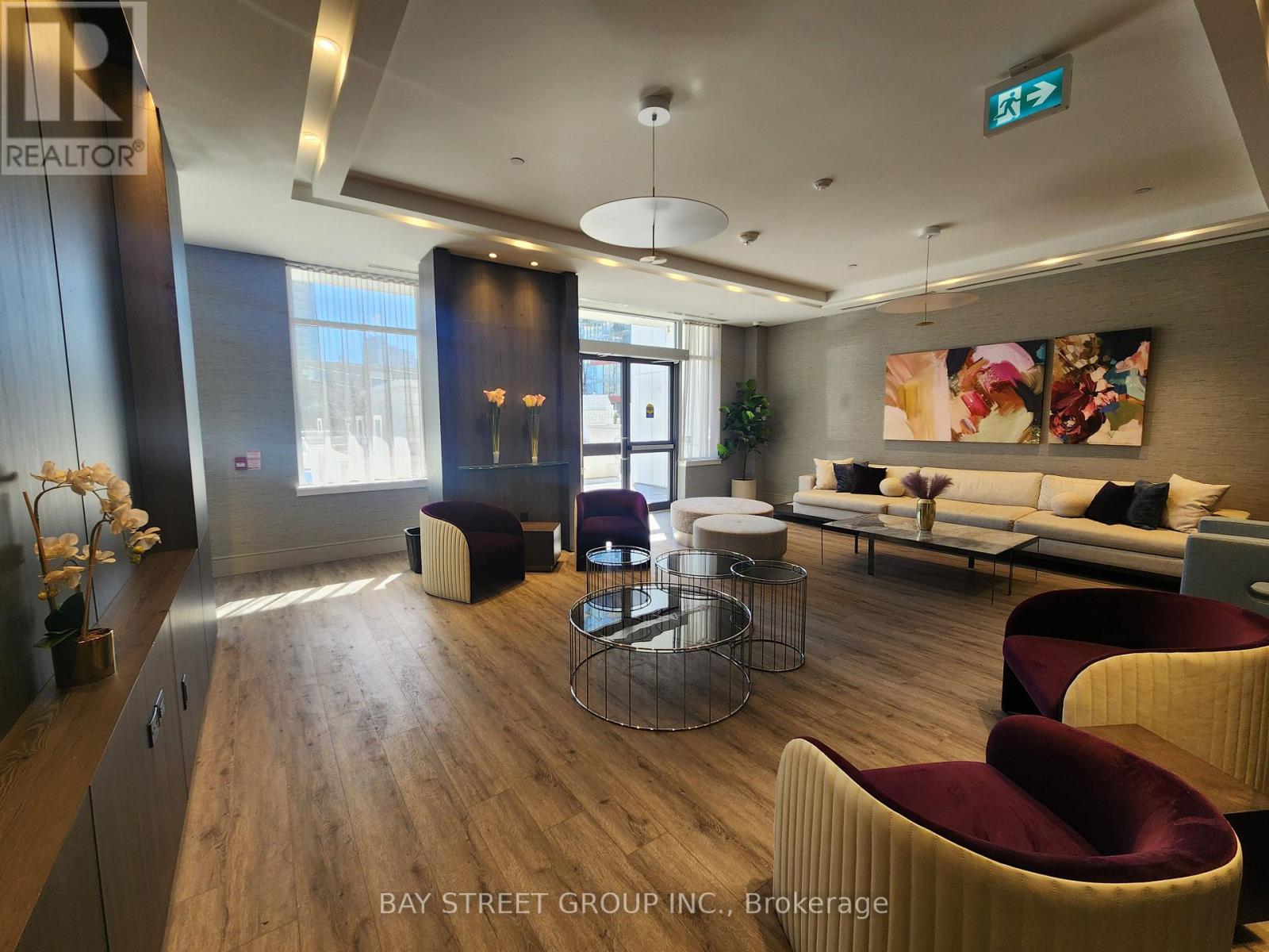 A modern living room with a wooden floor and a large window.