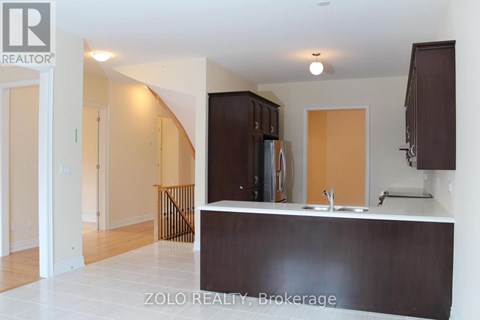 A kitchen area with brown cabinets and a white counter.