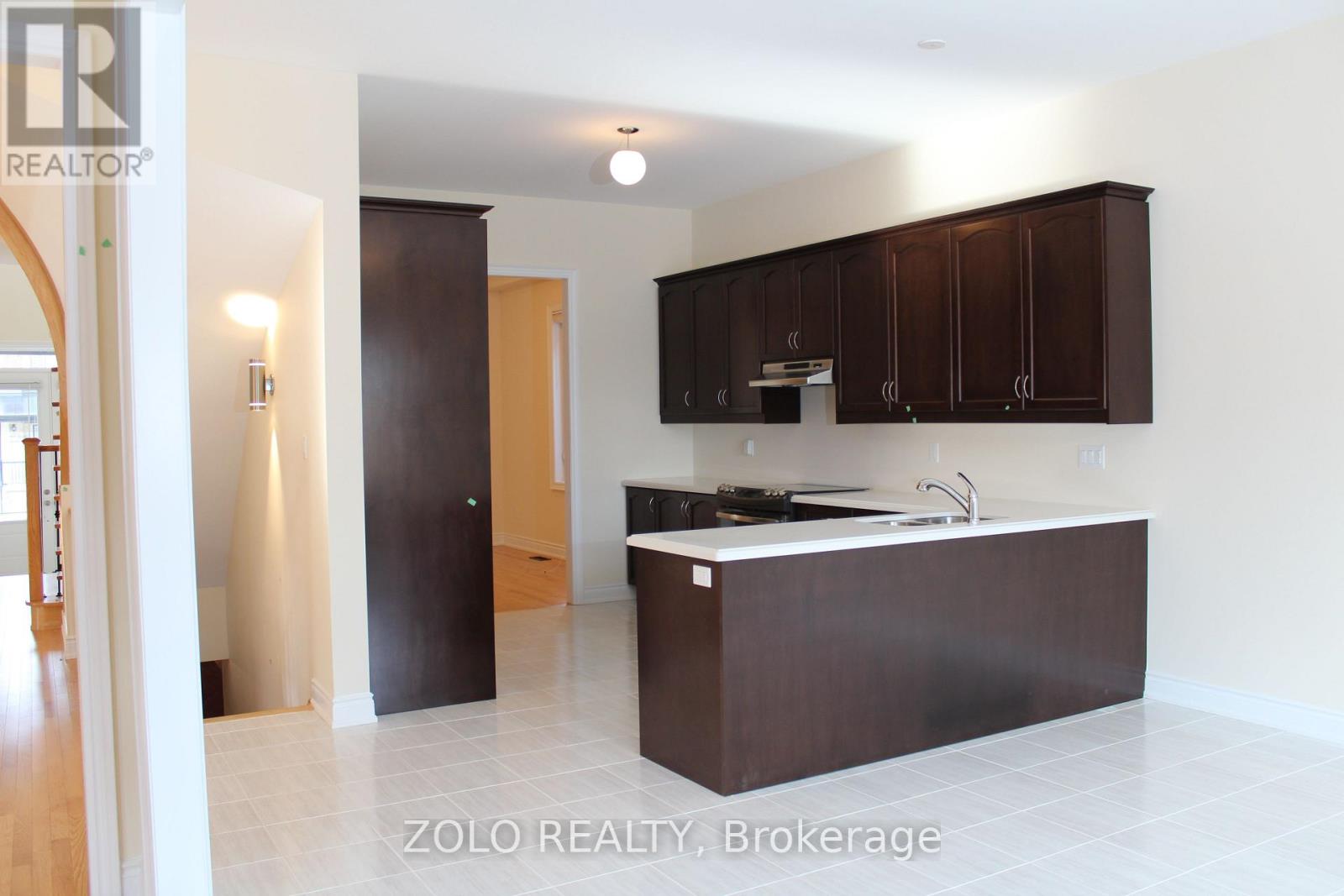 A kitchen with brown cabinets and a white counter top.