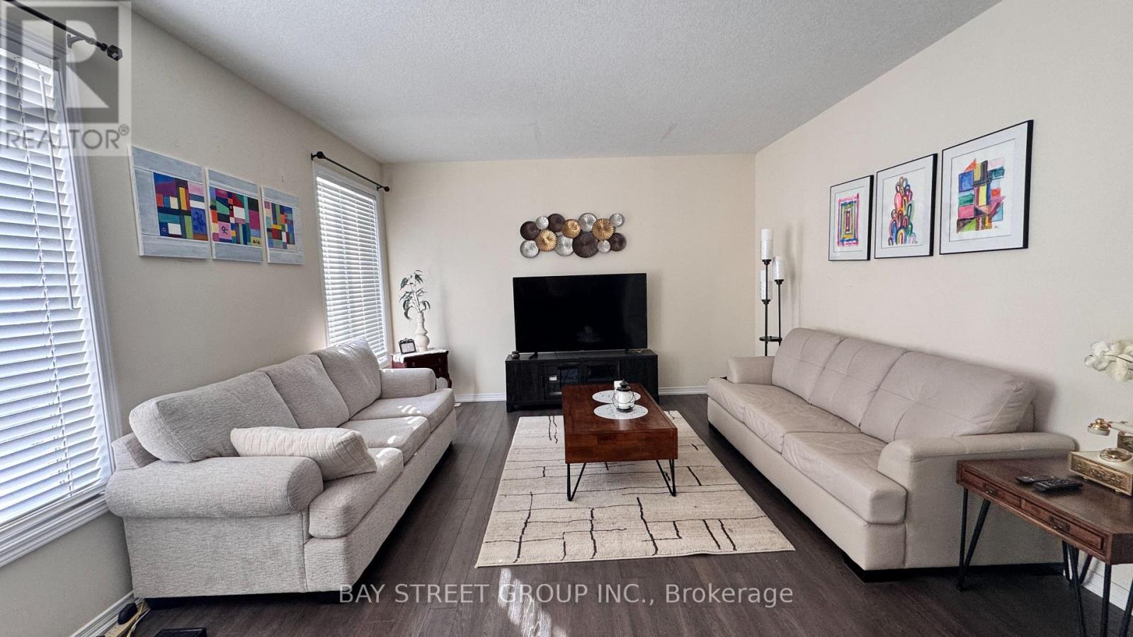 A living room with a grey couch, a white couch, and a coffee table.