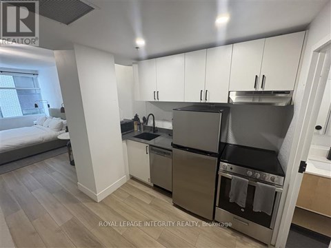 A kitchen with a stainless steel refrigerator and oven.
