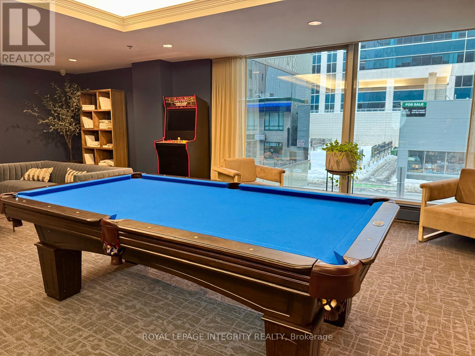A pool table in a room with a view of the city.