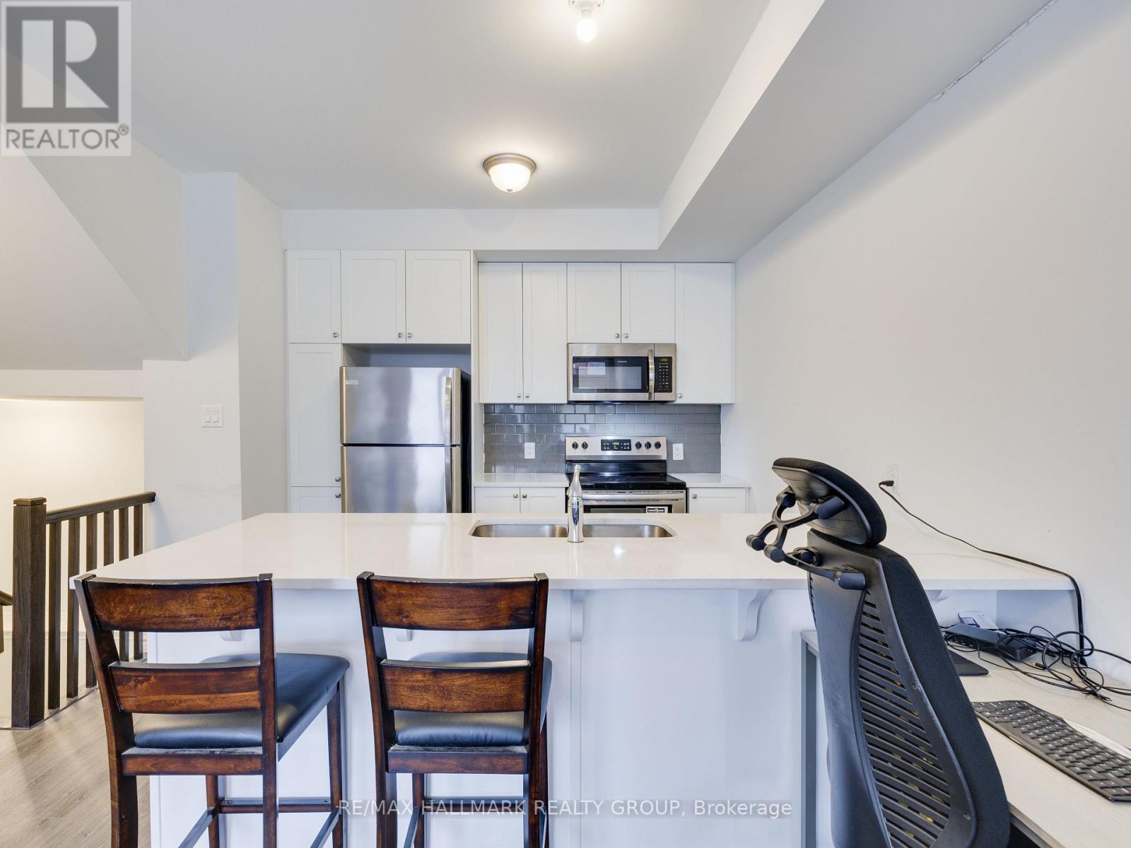 A modern kitchen with a dining table and chairs.