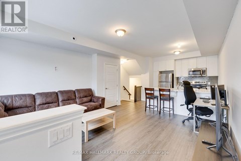 A living room with a brown leather couch and a white coffee table.