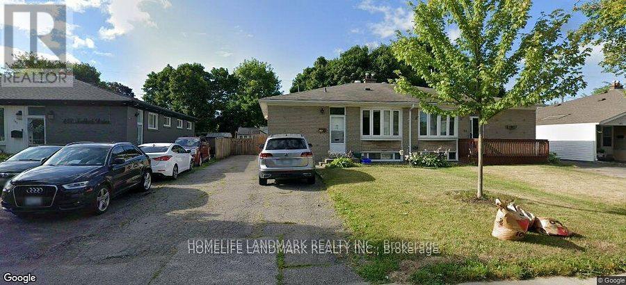 A street view of a residential area with cars parked and a house with a sign "HOMELIFE LANBREAK REALTY INC. BIRKENHEAD".