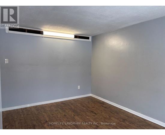 A bedroom with a bed, nightstand, and a dresser with a mirror.