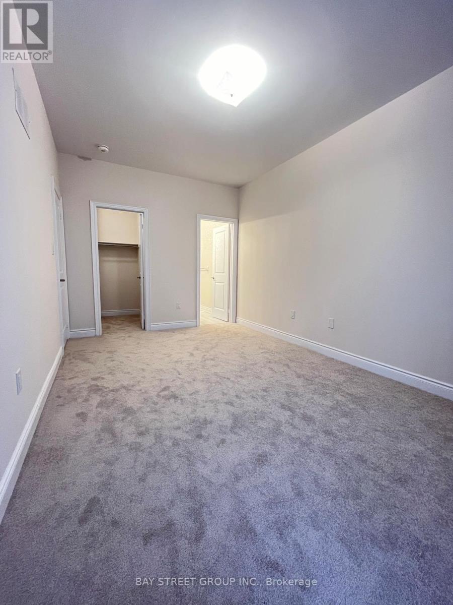 A spacious room with a carpeted floor and white walls.