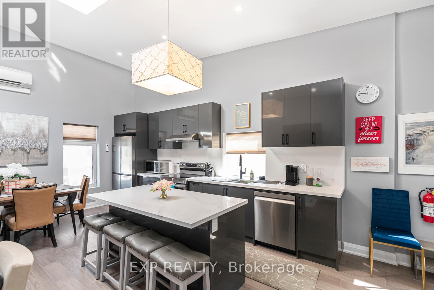A modern kitchen with a dining table and chairs.