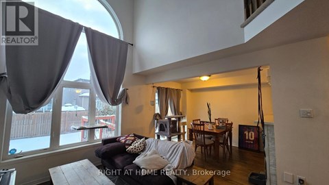 A living room with a couch and a dining table.