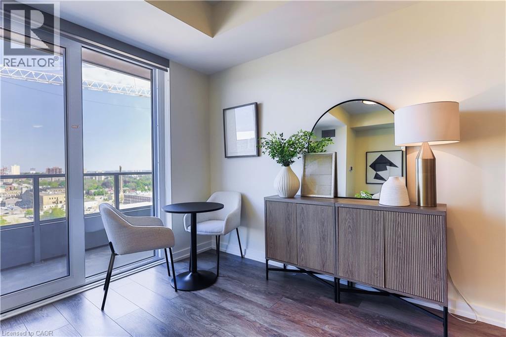 A living room with a table, chairs and a cabinet.