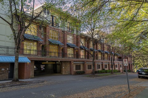 A street view of a building with a car parked in front.