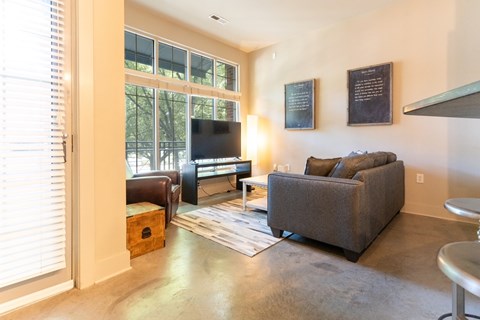 A living room with a grey couch and a flat screen TV.