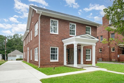 A red brick building with a white entrance.