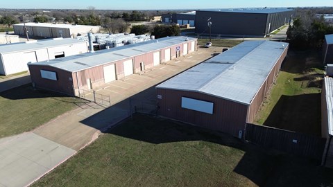 A large industrial complex with multiple buildings and a parking lot.