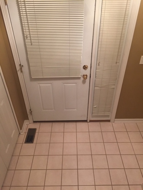A white door with a window above it.
