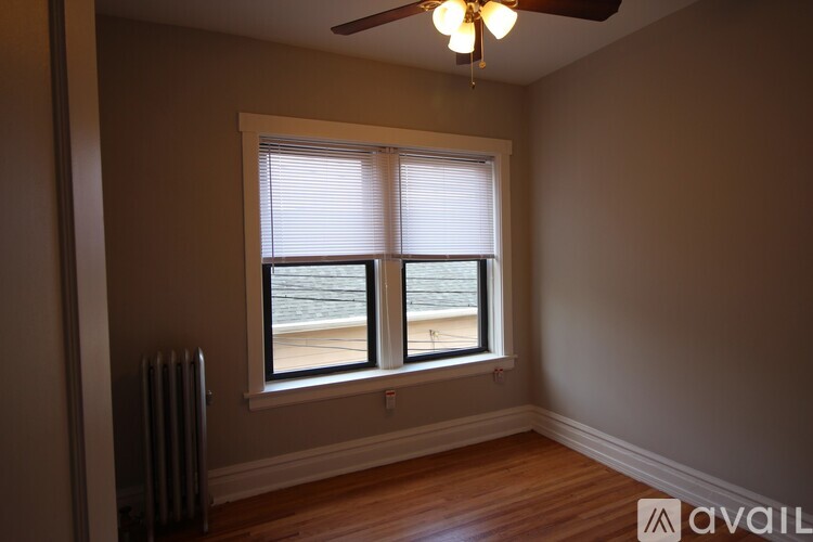 A room with a window and a ceiling fan.