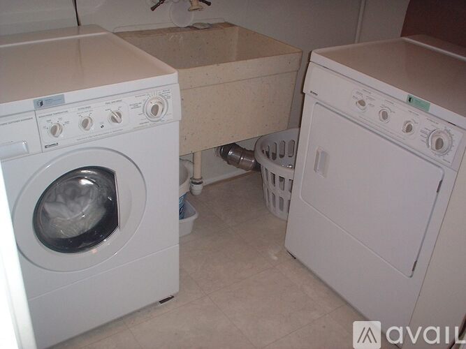 A white washing machine and dryer in a small laundry room.