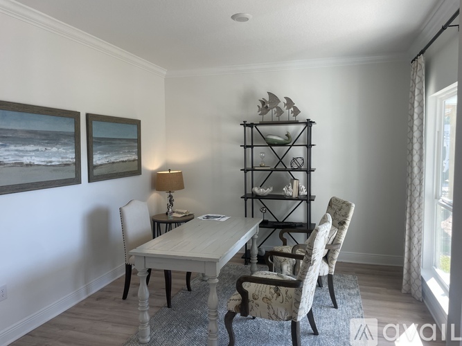 A dining room with a table and chairs.