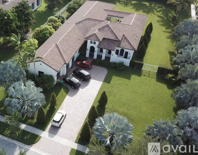 A house with a red car parked in front.