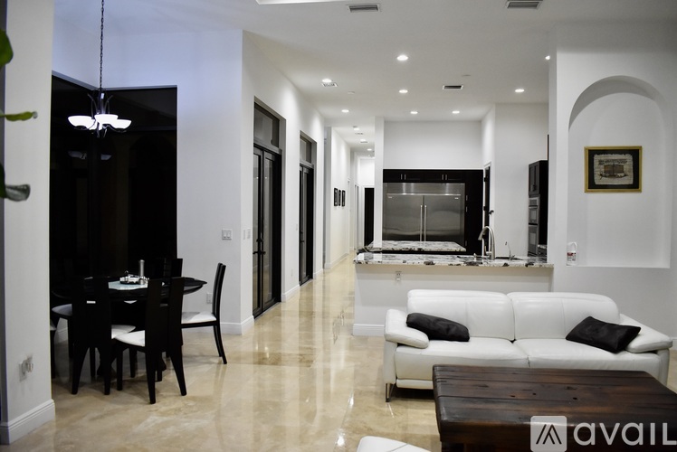 A modern living room with a dining table and a white sofa.
