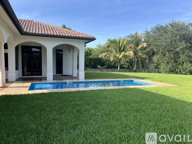 A house with a pool in the backyard.