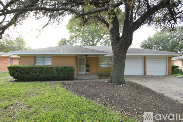 A house with a tree in front of it.