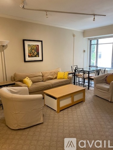 A living room with a couch, chair, and coffee table.