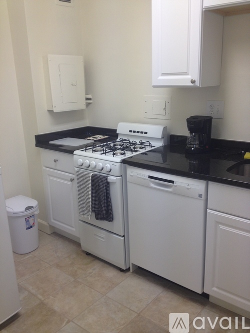 A kitchen with a white oven and black countertop.