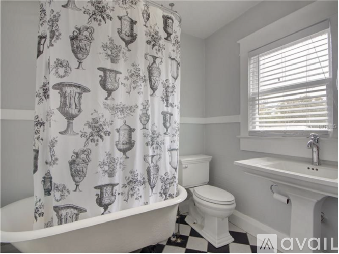 A bathroom with a black and white checkered floor.