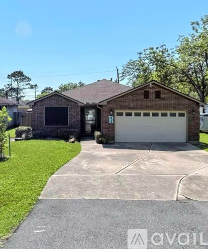 A house with a garage and a driveway in front.