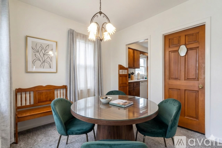 A spacious room with a carpeted floor and a staircase leading to the upper level.
