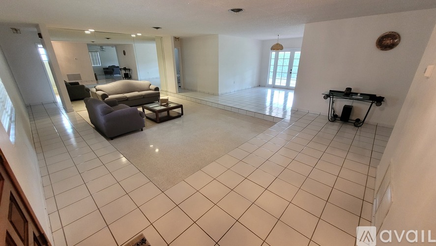 A spacious living room with a couch, chair, and coffee table.