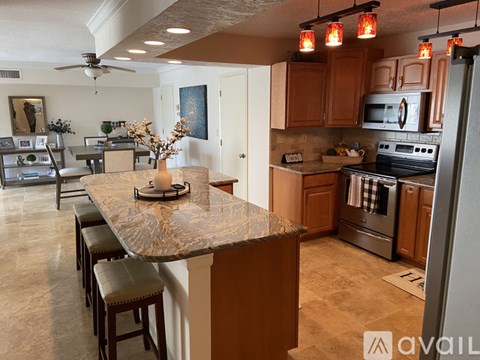 A kitchen with a counter and a refrigerator.