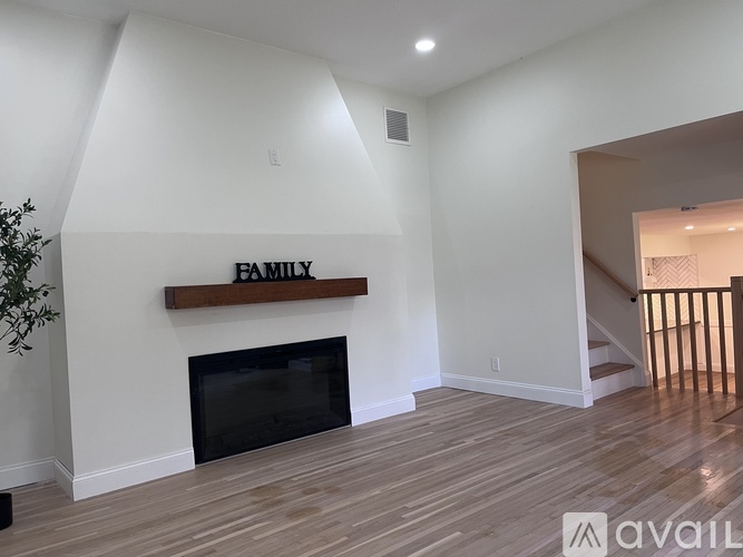 A living room with a fireplace and a sign that says "FAMILY".
