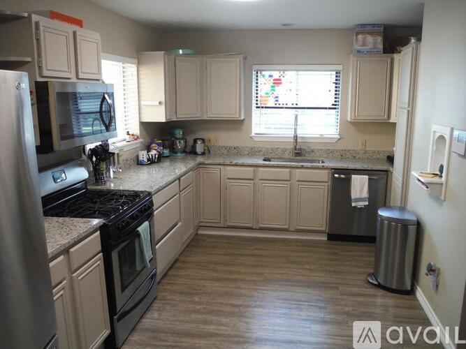 A kitchen with wooden cabinets and a black stove top.