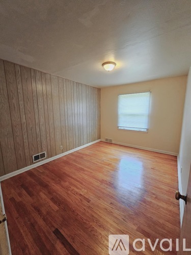 A room with wooden floors and a window.
