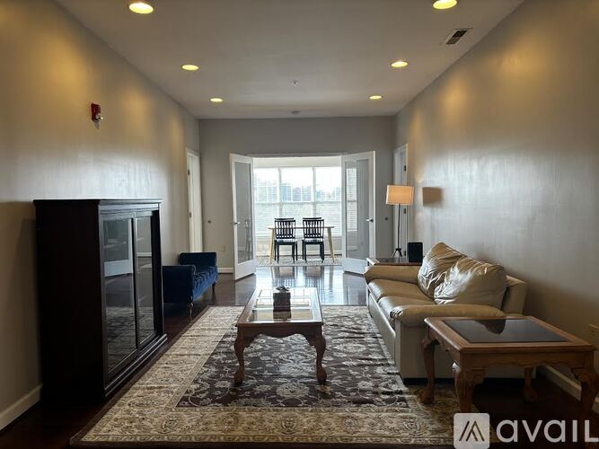 A living room with a couch, coffee table, and a fireplace.