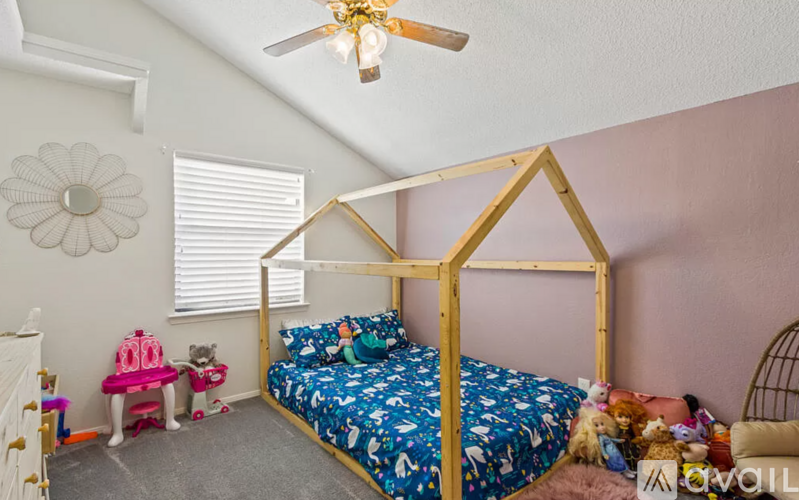 A bedroom with a four-poster bed and a dog.