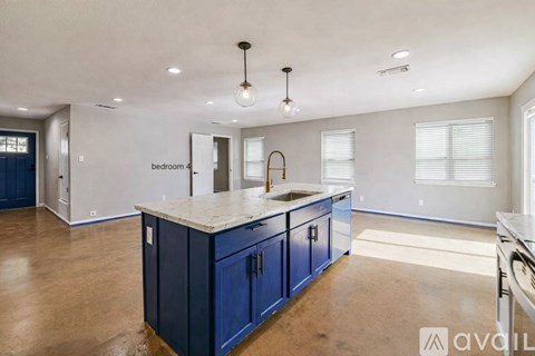 A kitchen with blue cabinets and a countertop is available for rent.