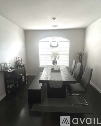 A dining room with a wooden table and chairs.