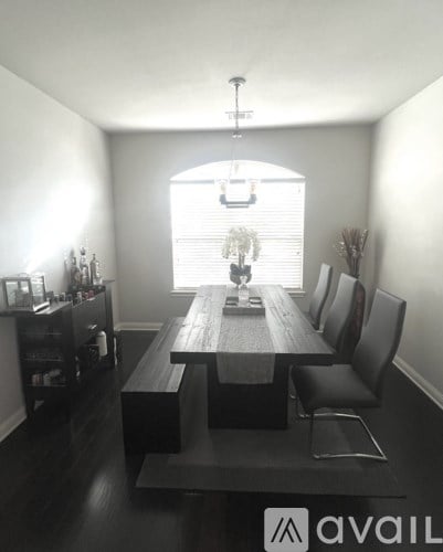 A dining room with a wooden table and chairs.