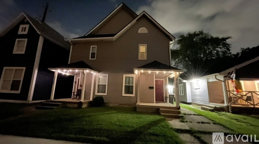 A house with a lit up front porch is available for sale.