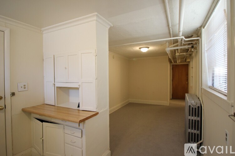 A kitchen area with a counter and cabinets.
