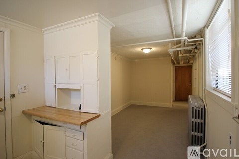 A kitchen area with a counter and cabinets.