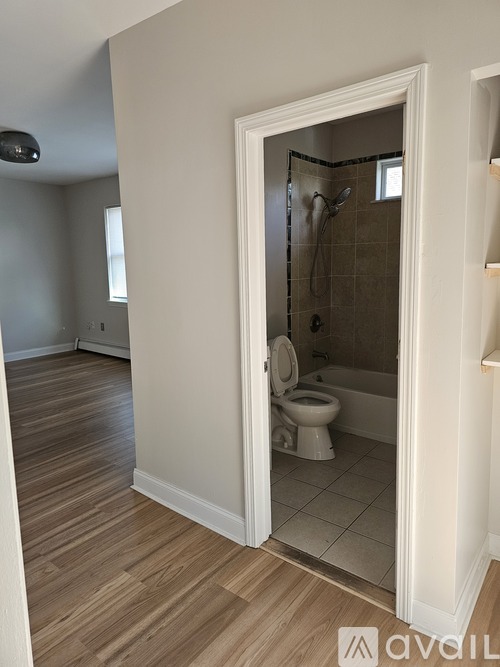 A bathroom with a toilet and a walk-in shower.