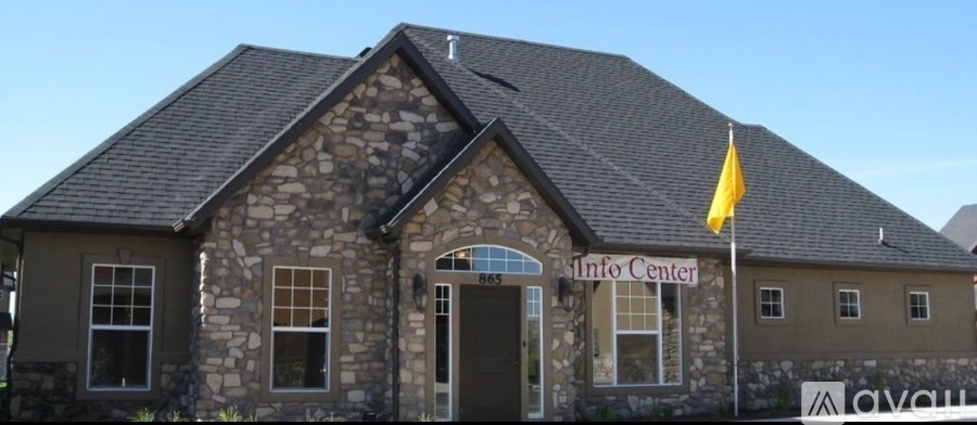 A stone building with a yellow flag on top of it.