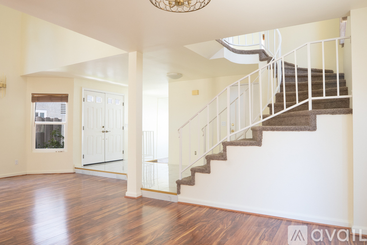 A large open space with a staircase leading to the upper floor.