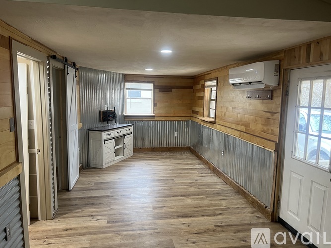 A room with wooden floors and a window.
